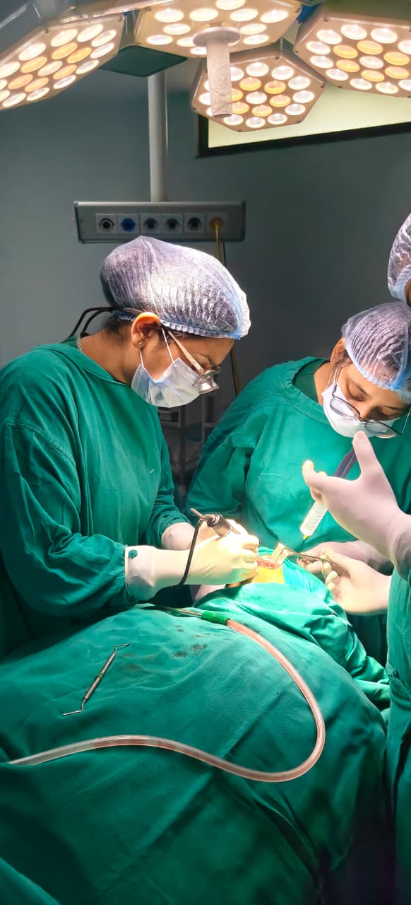 Dr. Bhavya Soni focused during a clinical procedure with assistant